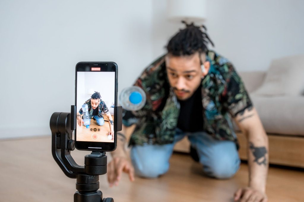 Small business owner filming short form video content with a smartphone on a gimbal