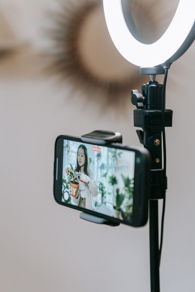 Smartphone with a ring light recording a live video of a product demonstration